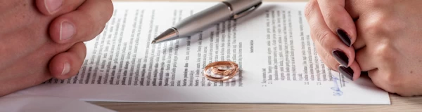 online divorce: husband and wife signing divorce papers